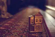 brown wooden house miniature on red carpet